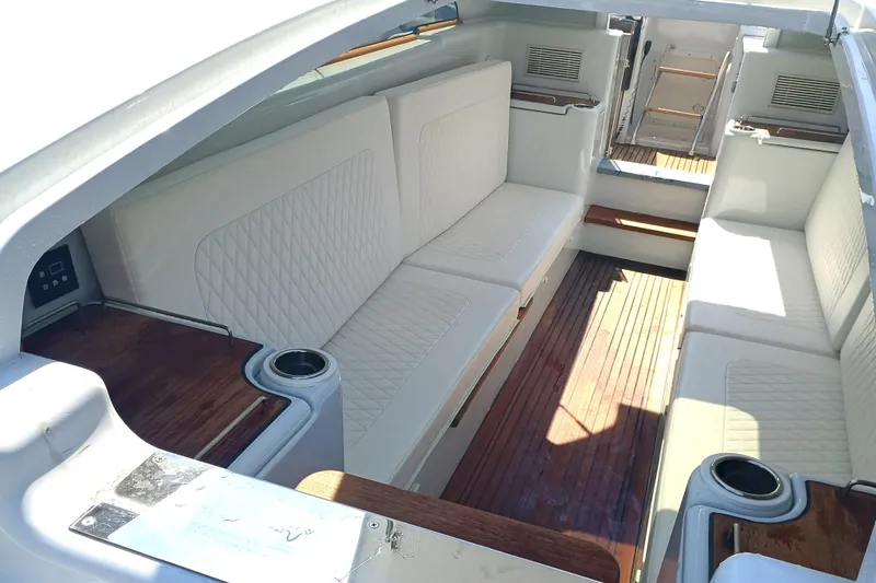 Slide: The Image of Luxurious 2006 Royal Denship Royal Limo interior with white seating and wooden accents. - 12