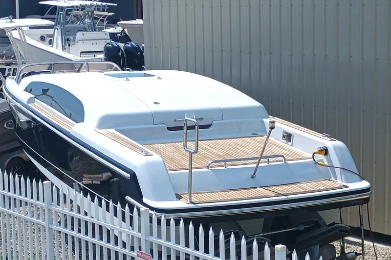 Slide: The Image of 2006 Royal Denship Royal Limo yacht docked near a white fence. - 5