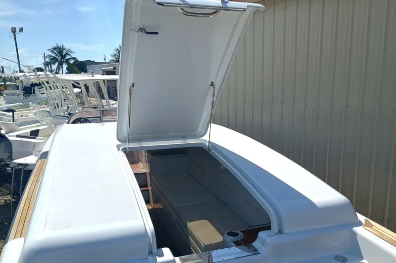 Slide: The Image of 2006 Royal Denship Royal Limo boat with open hatch, docked near other vessels. - 9