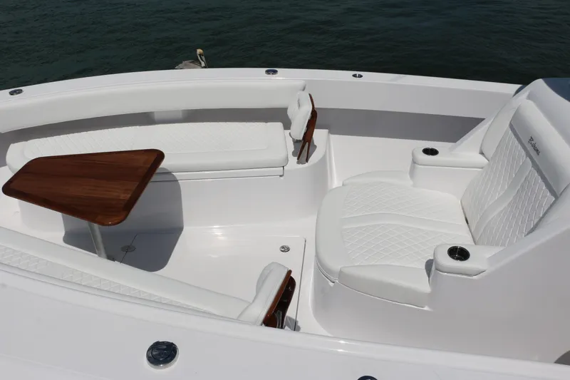 Slide: The Image of Luxurious seating area on 2026 Bahama 41 GT boat with white upholstery and wooden table. - 12