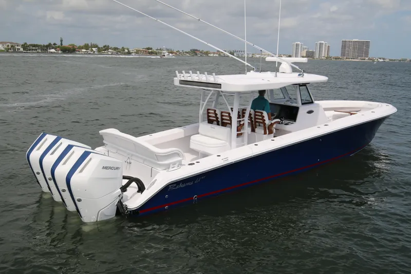 Slide: The Image of 2026 Bahama 41 GT boat with triple Mercury engines cruising on open water. - 15