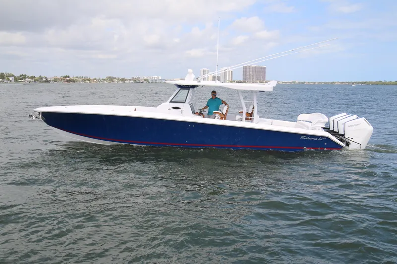 Slide: The Image of 2026 Bahama 41 GT boat cruising on open water with triple Mercury engines. - 27