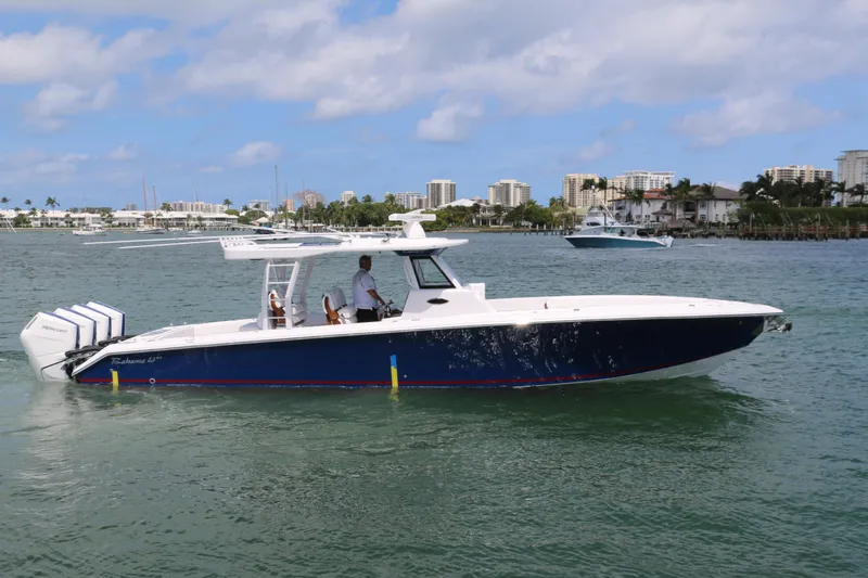 Slide: The Image of 2026 Bahama 41 GT boat cruising on a sunny day with city skyline in background. - 3