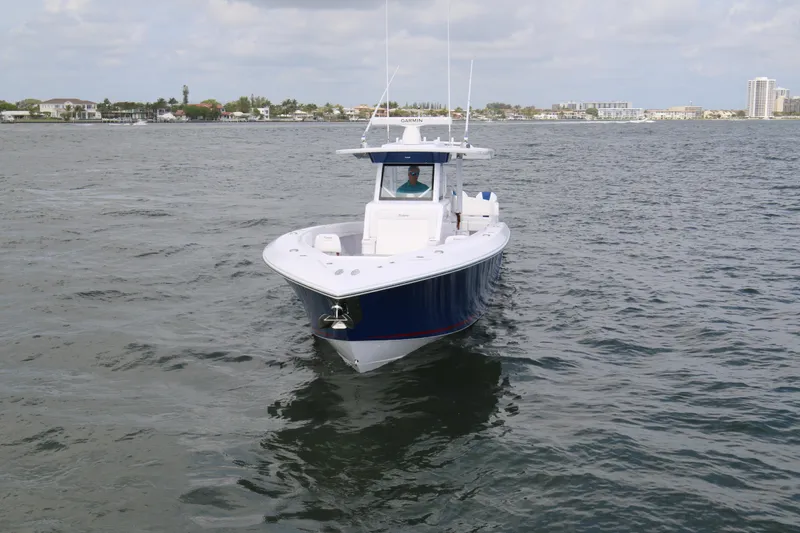 Slide: The Image of 2026 Bahama 41 GT boat cruising on open water under cloudy skies. - 41