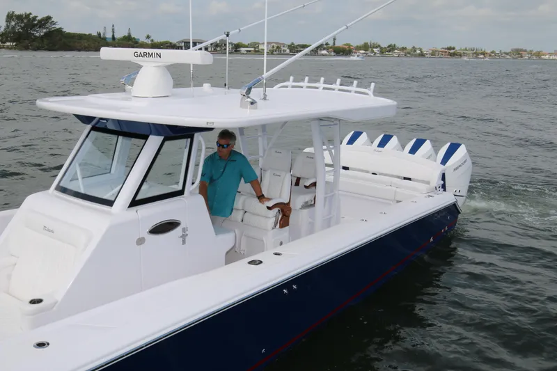Slide: The Image of 2026 Bahama 41 GT boat cruising on water with Garmin navigation system. - 52
