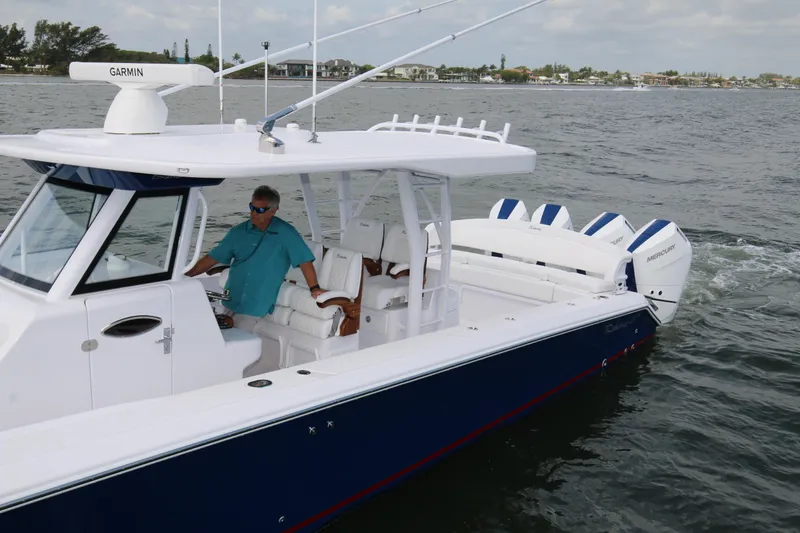 Slide: The Image of 2026 Bahama 41 GT boat cruising on water with Garmin navigation system. - 53