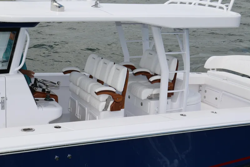 Slide: The Image of 2026 Bahama 41 GT boat interior with white cushioned seating and sleek design. - 58