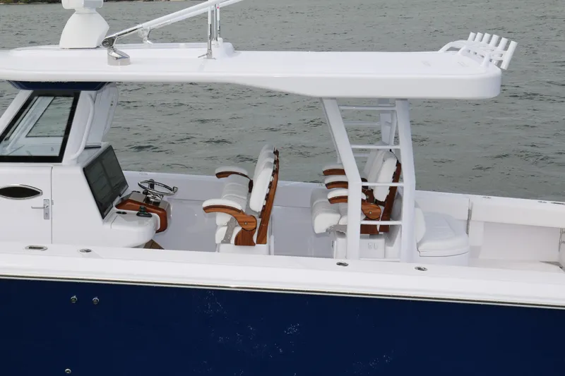 Slide: The Image of 2026 Bahama 41 GT boat with sleek design, white seating, and modern helm. - 66