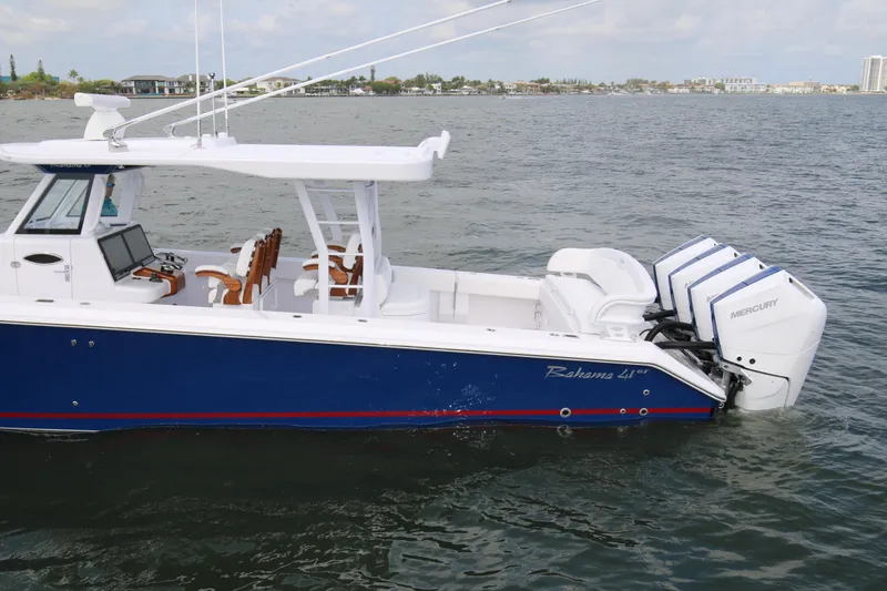 Slide: The Image of 2026 Bahama 41 GT boat with triple Mercury engines on the water. - 70