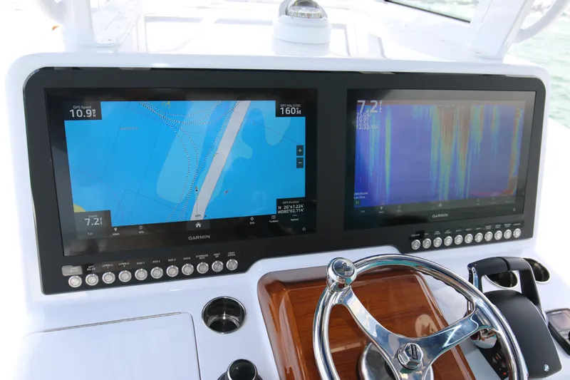 Slide: The Image of Dashboard of 2026 Bahama 41 GT with dual Garmin navigation screens and steering wheel. - 71