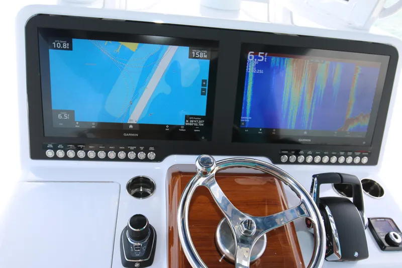 Slide: The Image of Dashboard of 2026 Bahama 41 GT with dual Garmin displays and steering wheel. - 74