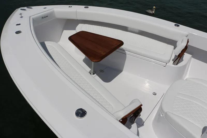Slide: The Image of Luxury seating area on 2026 Bahama 41 GT boat with wooden table and white cushions. - 79