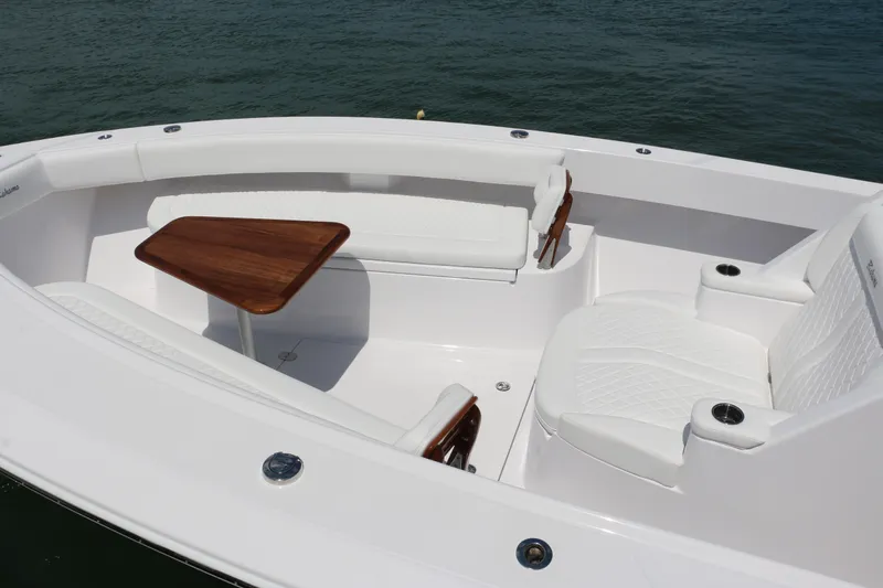 Slide: The Image of Luxurious seating area on 2026 Bahama 41 GT boat with wooden table and white cushions. - 81