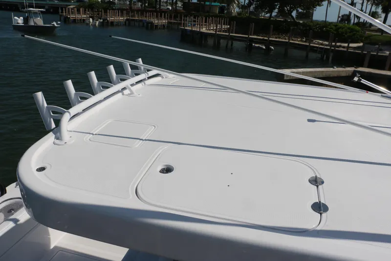 Slide: The Image of 2026 Bahama 41 GT boat deck with rod holders, docked in marina. - 83