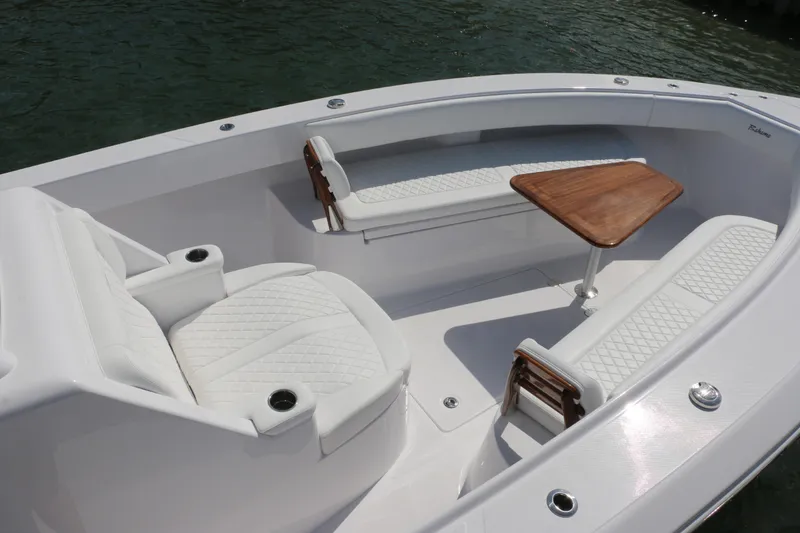 Slide: The Image of Luxurious seating area on 2026 Bahama 41 GT boat with elegant white upholstery and wooden table. - 84