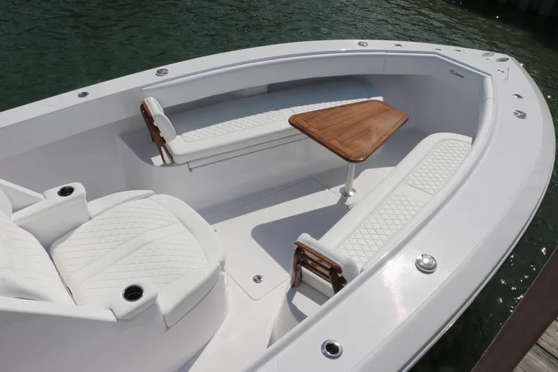 Slide: The Image of Luxurious seating area on 2026 Bahama 41 GT boat with elegant white upholstery and wooden table. - 86