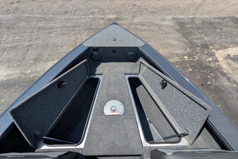 Slide: The Image of 2026 Lund 1875 Crossover XS boat interior with open storage compartments. - 14