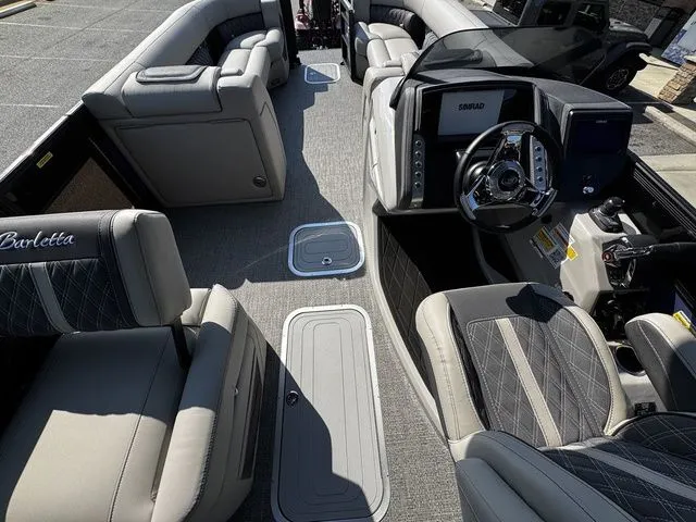 Slide: The Image of 2025 Barletta Lusso L25MAT boat interior with luxurious seating and modern dashboard. - 14