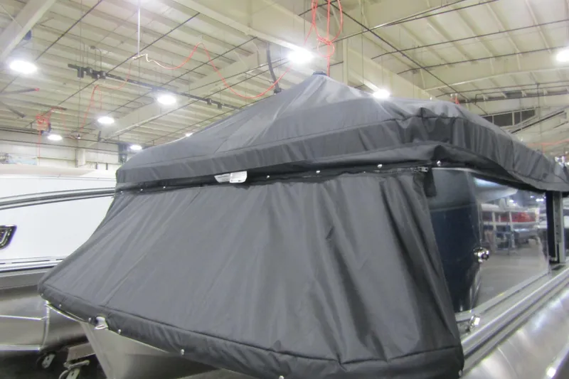 Slide: The Image of 2026 Avalon VENTURE CRUISE boat with black canopy in a warehouse setting. - 9