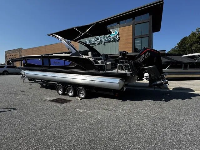 The Image of 2025 Barletta Lusso L25MAT pontoon boat parked outside Rock Outdoors store. - 1
