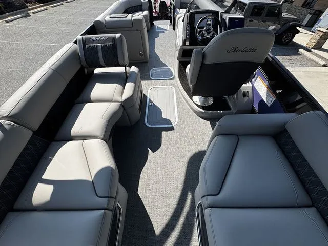 Slide: The Image of 2025 Barletta Lusso L25MAT boat interior with luxurious seating and modern helm. - 13