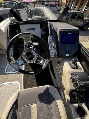 Slide: The Image of 2025 Barletta Lusso L25MAT boat dashboard with steering wheel and navigation system. - 15