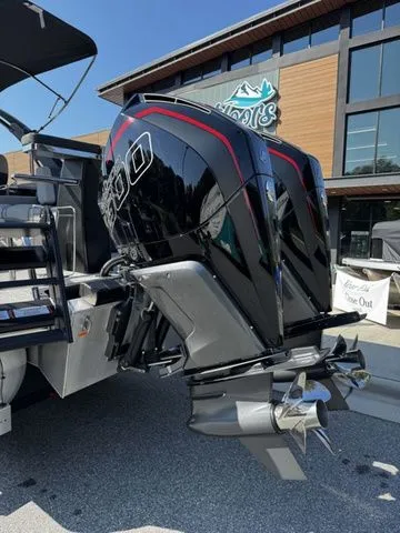 Slide: The Image of 2025 Barletta Lusso L25MAT boat with powerful dual outboard motors, displayed outdoors. - 5