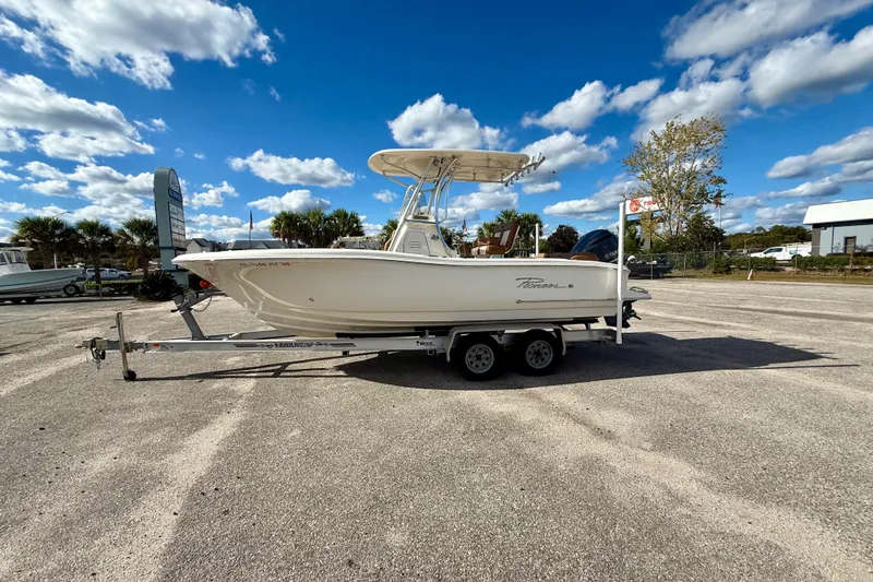 The Image of 2024 Pioneer 222 Islander boat on trailer under blue sky. - 0