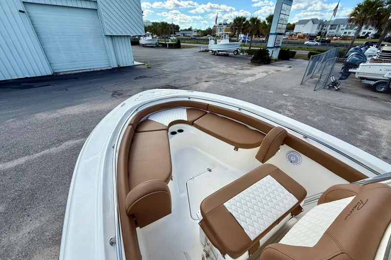 Slide: The Image of 2024 Pioneer 222 Islander boat with tan seating, docked outdoors. - 7