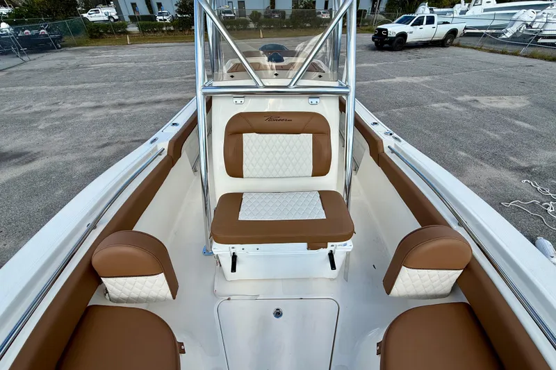 Slide: The Image of 2024 Pioneer 222 Islander boat interior with brown and white seating. - 8