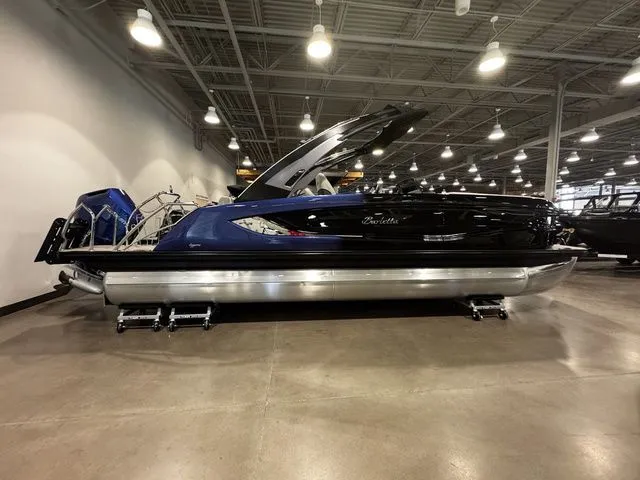 The Image of 2025 Barletta Boats R23UCA pontoon in showroom, featuring sleek design and modern lighting. - 1