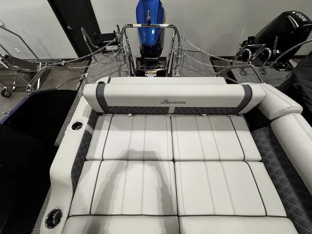 Slide: The Image of 2025 Barletta Boats R23UCA interior with luxurious white seating and modern design. - 7