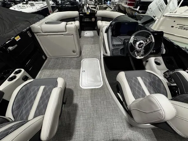 Slide: The Image of Luxurious interior of 2025 Barletta Boats R23UCA with plush seating and modern dashboard. - 9