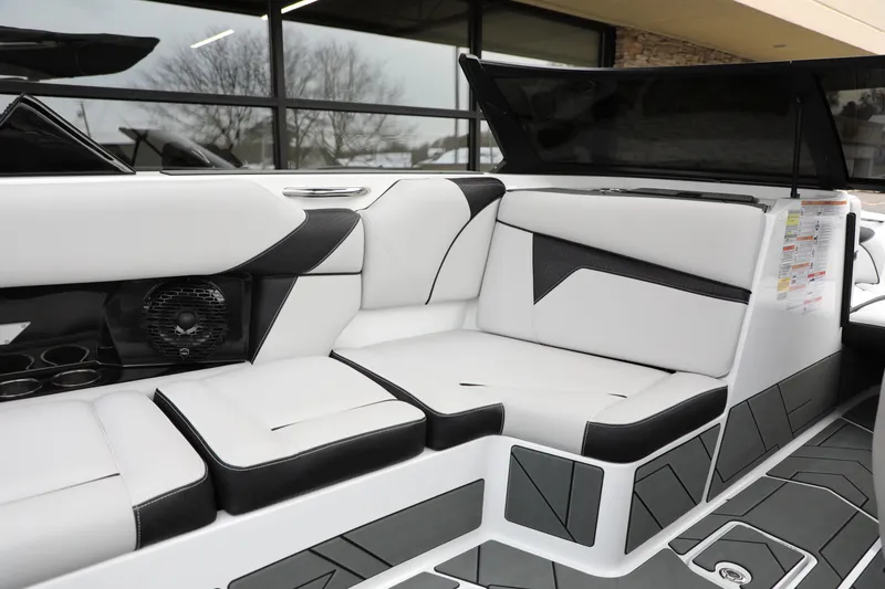 Slide: The Image of 2026 Supreme S220 boat interior with sleek white and black seating design. - 11