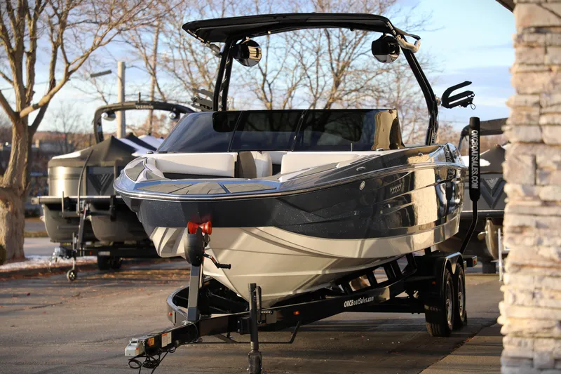 Slide: The Image of 2026 Supreme S220 boat on trailer, parked outdoors in a sunny setting. - 4