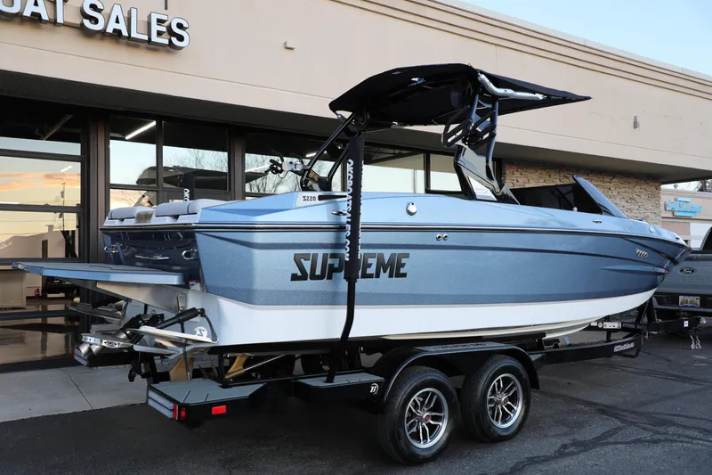 Slide: The Image of 2026 Supreme S220 boat on trailer at dealership, showcasing sleek design and modern features. - 5