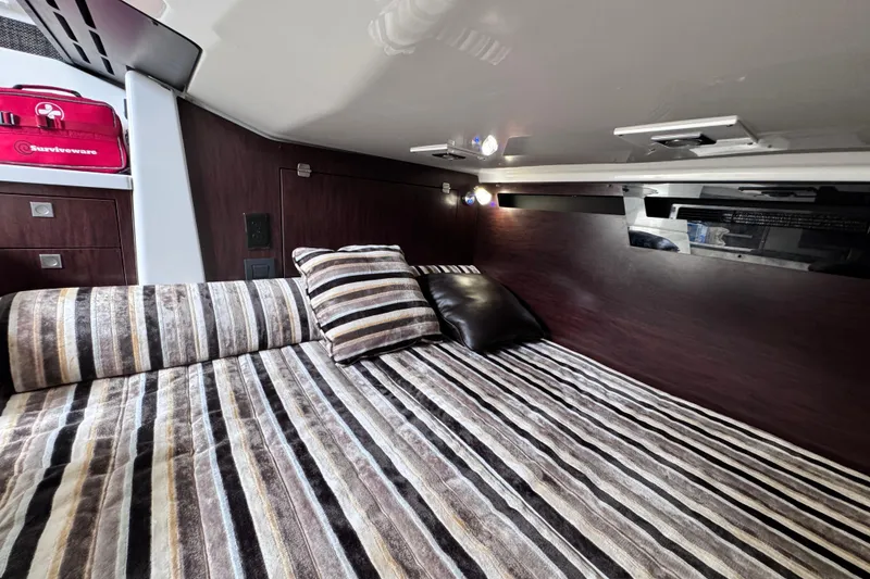 Slide: The Image of Luxurious cabin interior of 2021 Monterey 378 Super Express with striped bedding and cushions. - 11