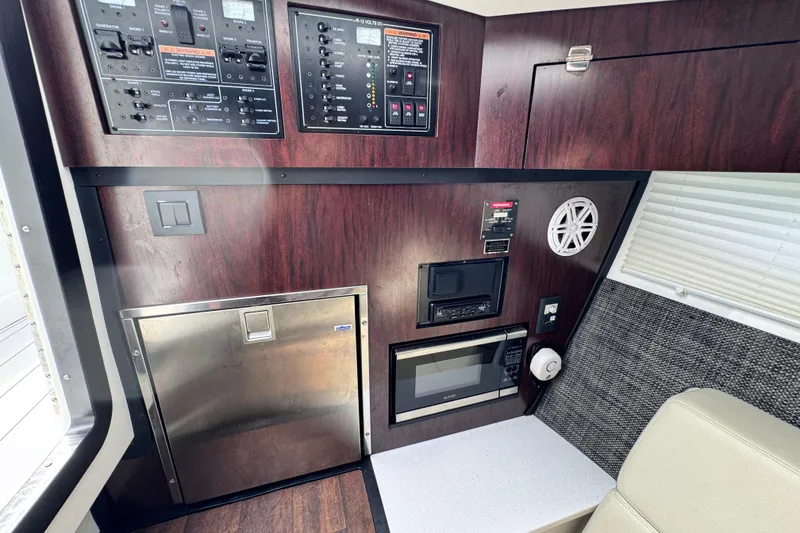 Slide: The Image of 2021 Monterey 378 Super Express interior with control panels, microwave, and wood finish. - 15