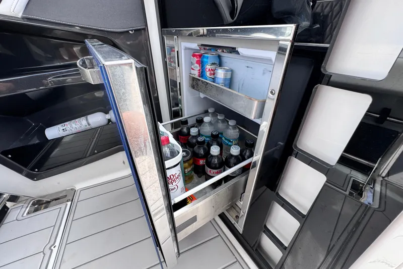 Slide: The Image of Open mini fridge on 2021 Monterey 378 Super Express boat, stocked with drinks. - 19