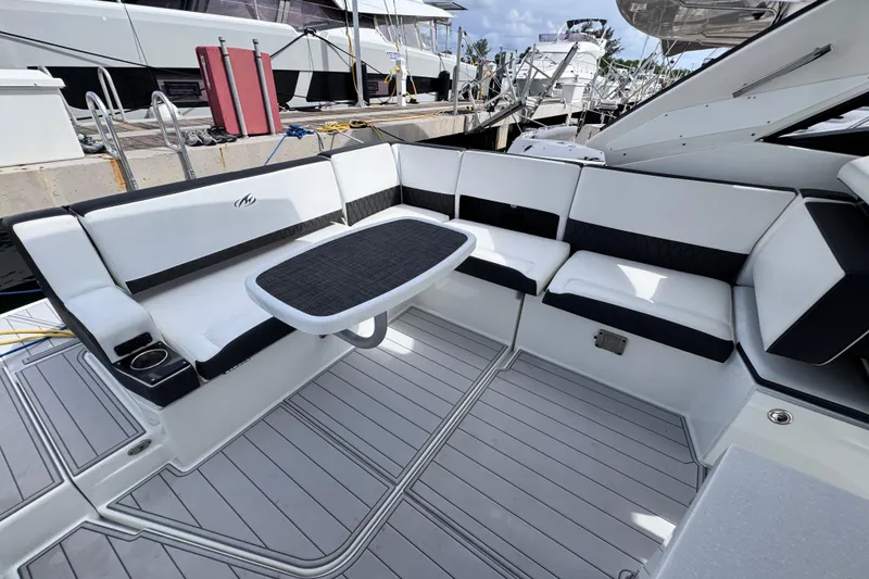 Slide: The Image of Luxurious seating area on a 2021 Monterey 378 Super Express yacht, docked at a marina. - 20