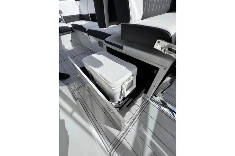Slide: The Image of 2021 Monterey 378 Super Express boat interior with storage compartment and cooler. - 23