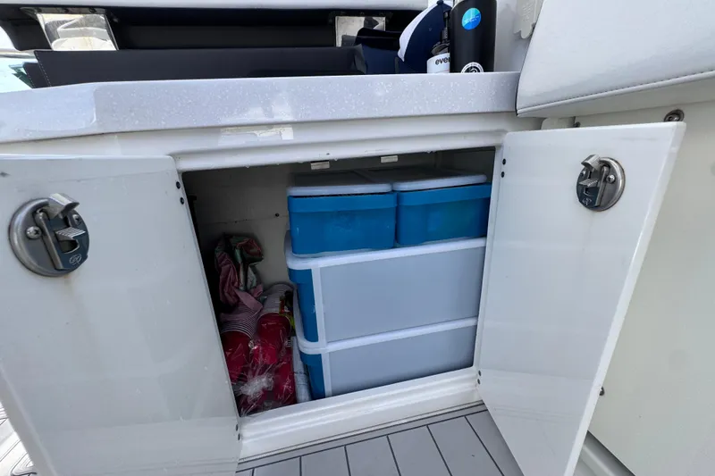 Slide: The Image of Storage compartment on 2021 Monterey 378 Super Express boat with containers and supplies. - 27