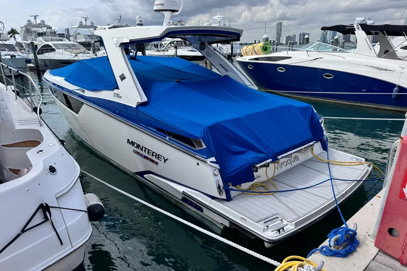 Slide: The Image of 2021 Monterey 378 Super Express boat docked with blue cover in marina. - 5