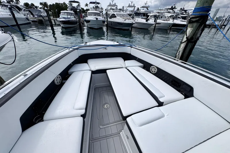 Slide: The Image of 2021 Monterey 378 Super Express boat interior with white seating at marina. - 8