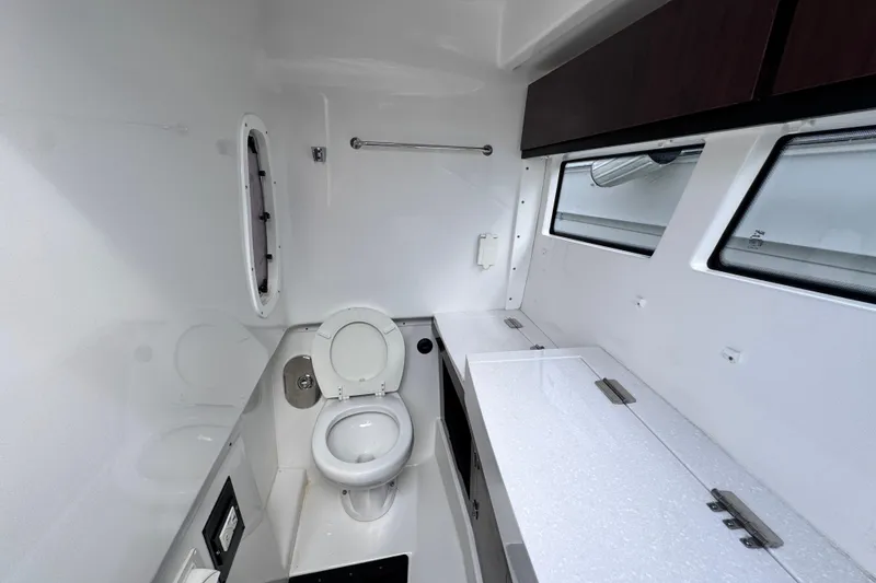 Slide: The Image of Interior of 2021 Monterey 378 Super Express boat bathroom with toilet and countertop. - 9