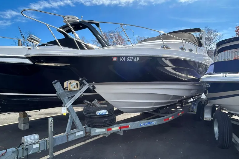 The Image of 2004 Regal Commodore 2860 boat on trailer under clear blue sky. - 0