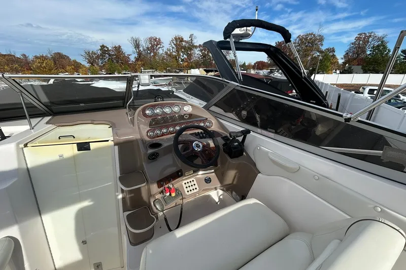 Slide: The Image of 2004 Regal Commodore 2860 boat cockpit with steering wheel and control panel. - 16