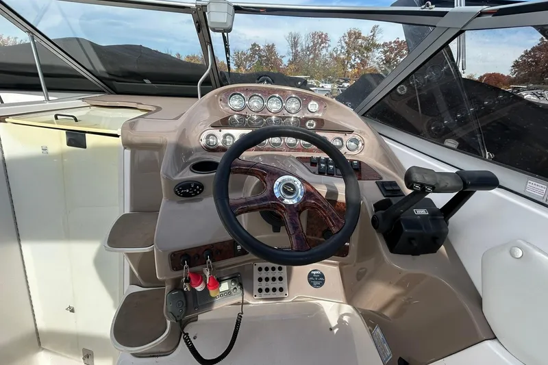 Slide: The Image of Steering console of 2004 Regal Commodore 2860 boat with gauges and controls. - 17