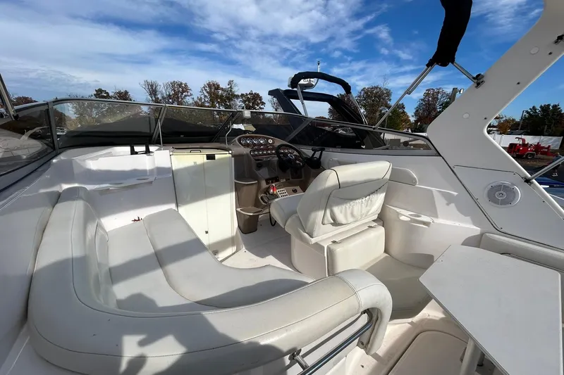 Slide: The Image of 2004 Regal Commodore 2860 boat interior with white seating and control panel. - 18