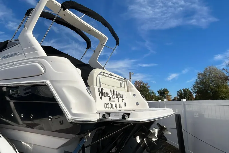 Slide: The Image of 2004 Regal Commodore 2860 boat docked under a clear blue sky. - 4